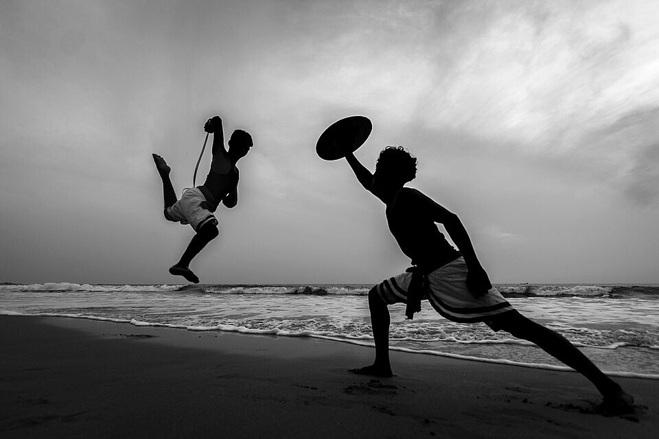 Kalaripayattu martial artists practising on a Kerala beach