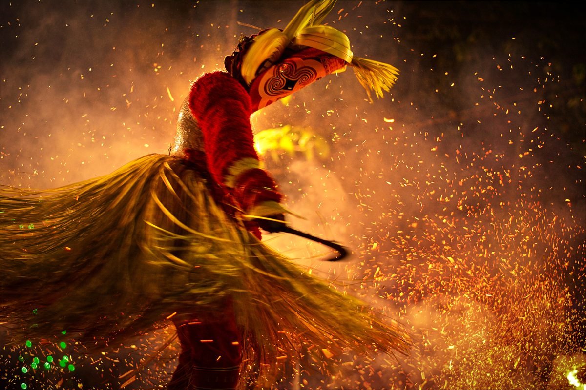 Theyyam ritual performer amid sparks and fire