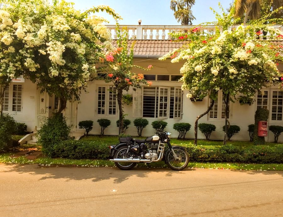 Heritage Kerala bungalow with a classic motorcycle