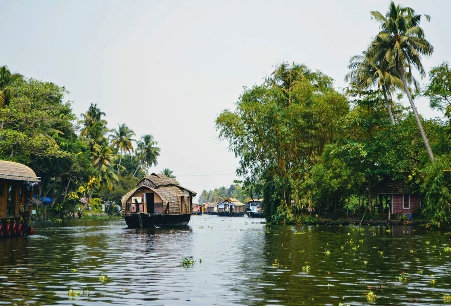 Traditional houseboat village along a Kerala canal