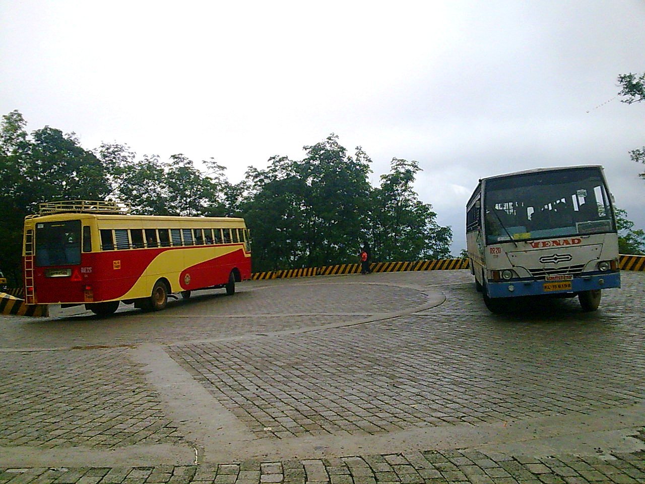 Tour buses on a scenic Kerala ghat road